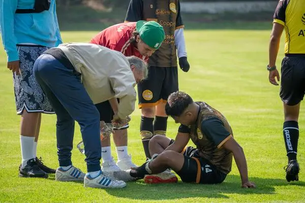 doctor treating sports injury on field