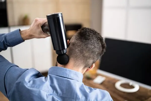 Man using neck massage machine
